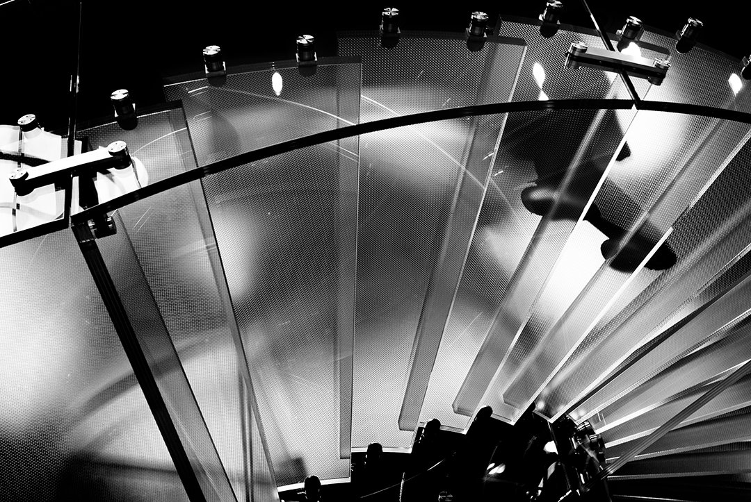 Feet seen through the steps of a staircase.
